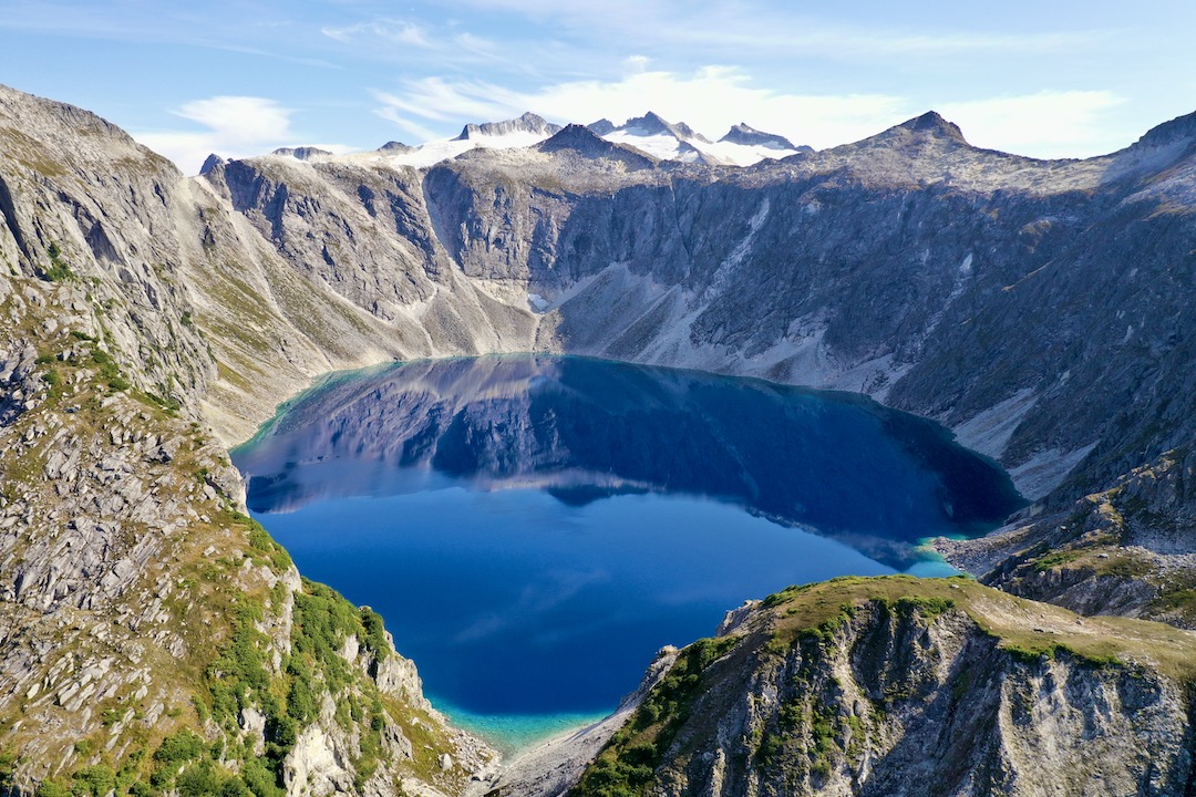 Very large alpine lake in a mountainous bowl. Looks kind of like a volcana caldera but it is not.